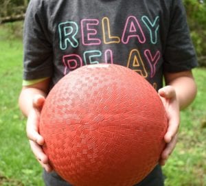 Boy holding ball in the backyard