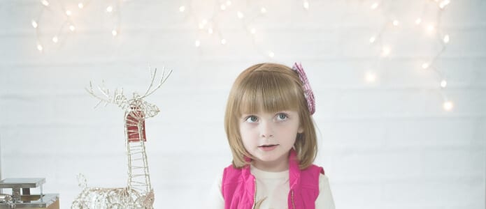 child with string lights