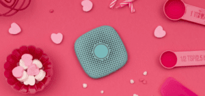 mint relay on a pink background surrounded by candy hearts and baking supplies
